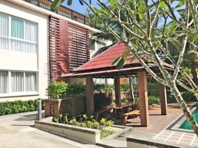 a gazebo with a picnic table in front of a building at Royal Lee Resort and Spa in Ban Bo Han