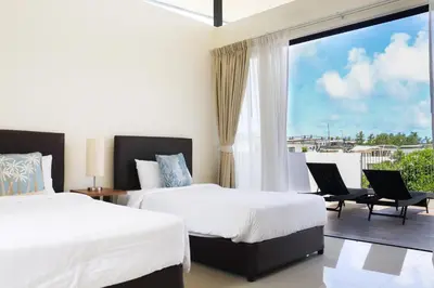 a bedroom with two beds and a large window at Super Friendly TH Laguna Park in Phuket Town