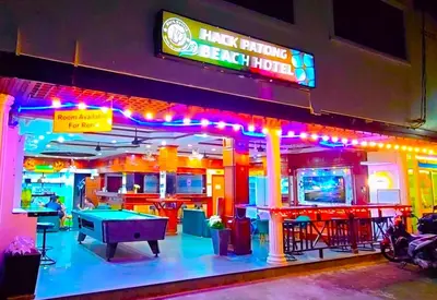 a restaurant with a ping pong table and neon lights at Hack Patong Beach Hotel in Patong Beach