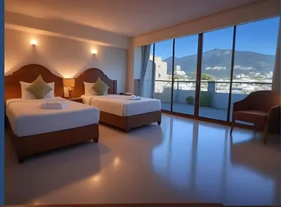 a hotel room with two beds and a chair and windows at Hack Patong Beach Hotel in Patong Beach
