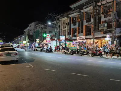 a busy city street at night with cars and motorcycles at 7 Floor - Studio Room at TBHR near Kata beach in Kata Beach