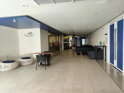 a hallway with a table and chairs in a building at 7 Floor - Studio Room at TBHR near Kata beach in Kata Beach