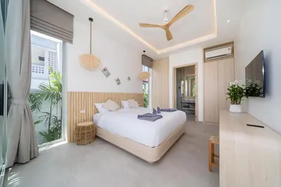 a bedroom with a large white bed and a television at Tropical Brand New 4BR Pool Villa Mina, just 5 min Drive from Naiharn in Rawai Beach