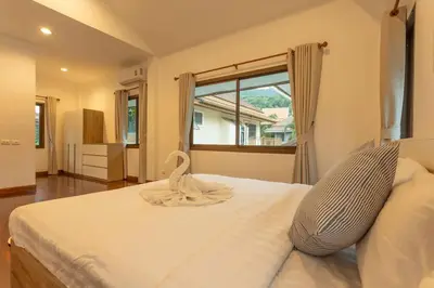 a bedroom with a large white bed with a window at Center Stay from Patong Bangla Walking Street V107 in Patong Beach
