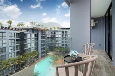 a balcony with a view of the pool and buildings at Tropics Pool View 2BR Kamala Apartment CTG P605-6, near Beach in Kamala Beach