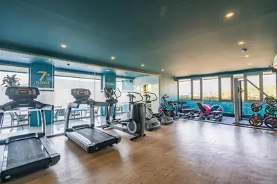 a gym with several treadmills and exercise bikes at Apartment with panoramic views at Oceana by Lofty in Kamala Beach
