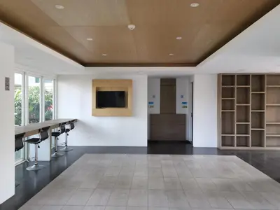 a room with a table and chairs and a television at 7 Floor - Mountain view Studio room at OZC near Kata beach in Kata Beach