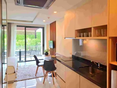 a kitchen with a counter and a table and chairs at Studio Apartment 400m from Rawai Beach in Phuket Town