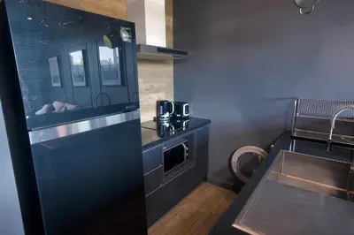 a kitchen with a sink and a counter top at Saturdays by Holy Cow, pool view in Rawai Beach