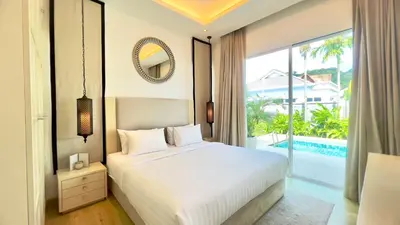 a bedroom with a bed and a large window at Kamala Garden View Baan Ratri 4 in Kamala Beach