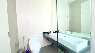 a bathroom with a sink and a toilet and a mirror at Kamala Garden View Baan Ratri 4 in Kamala Beach