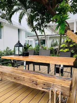 a wooden table and bench on a deck at Vipa Seaview Villa in Patong Beach
