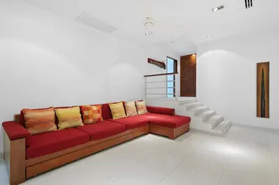 a living room with a red couch with yellow pillows at Kamala Hills Naka - Villa 15 in Kamala Beach