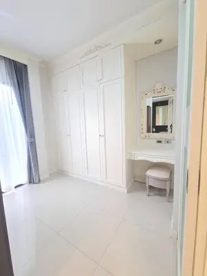 a white room with a vanity and a mirror at บ้านพัก น้ำตกกะทู้ in Ban Huai Luk (1)