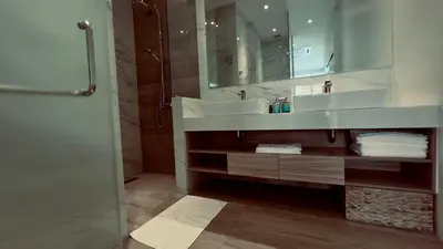 a bathroom with a sink and a shower with a mirror at Kamala Garden View Villas by Aladdin in Kathu