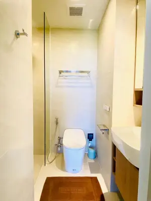 a bathroom with a toilet and a glass shower at Cozy 1BR in Laguna Skypark Celeste Bangtao, Iinfinity Pool in Bang Tao Beach