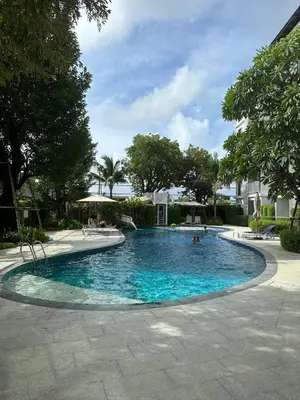 a large swimming pool with people in it at Title V Palm View 4fl Pool Gym Hammam in Rawai Beach
