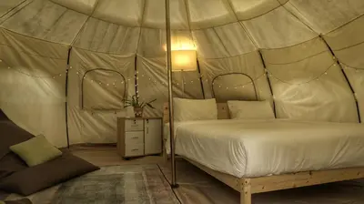 a bedroom with a bed in a tent at Bambus Restaurant, Bar & Glamping in Patong Beach