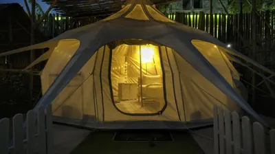 a tent with a light inside of it at Bambus Restaurant, Bar & Glamping in Patong Beach