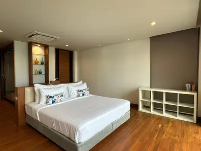 a bedroom with a large bed with white sheets and pillows at 4bedroom Villa Siray Beach Front in Phuket Town