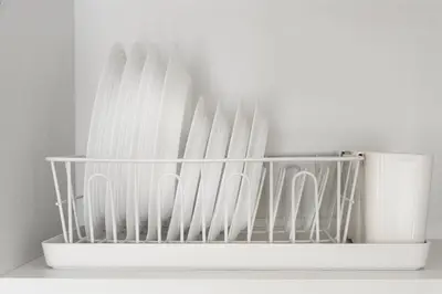 a bunch of white knives in a holder on a shelf at Title Halo Tenderness Naiyang Pool View Gym in Nai Yang Beach