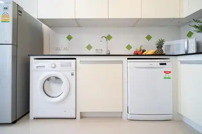 a kitchen with a washing machine and a dishwasher at 1 Bedroom Villa in Rawai - v19 t in Ban Saiyuan (1)