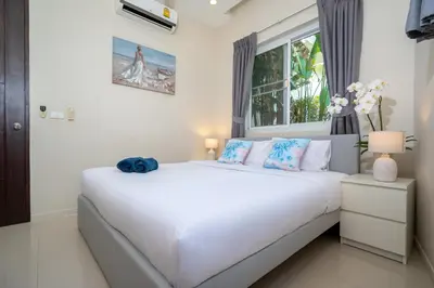 a white bed in a room with a window at 1 Bedroom Villa in Rawai - v19 t in Ban Saiyuan (1)