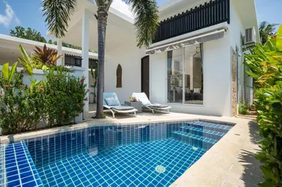 a swimming pool in the backyard of a villa at 1 Bedroom Villa in Rawai - v19 t in Ban Saiyuan (1)