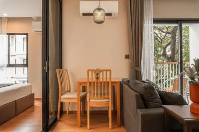 a living room with a table and a couch at Title V Summer Dream Pool View Gym Hammam in Rawai Beach