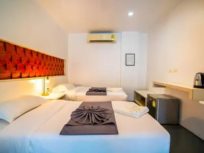 a hotel room with two beds in a room at The Thai Guesthouse and Hostel in Patong Beach