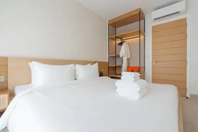 a bedroom with a large white bed and a closet at Laguna Lakeside apartments with panoramic view in Bang Tao Beach