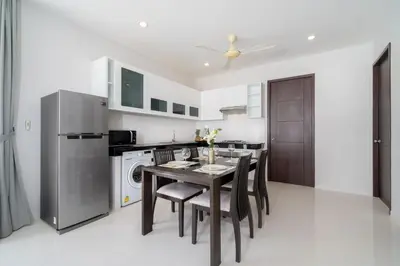 a kitchen and dining room with a table and chairs at 2 Bedrooms Villa in Rawai - v6 t in Ban Saiyuan (1)