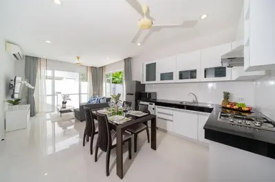 a kitchen and living room with a table and chairs at 2 Bedrooms Villa in Rawai - v6 t in Ban Saiyuan (1)