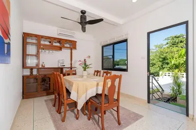 a dining room with a table and chairs at Golden Sands Villa only 15 minutes walk to beach in Surin Beach