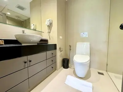 a bathroom with a white toilet and a sink at Allamanda Laguna Phuket 2 bedroom apartment Bang Tao Beach in Laguna Phuket