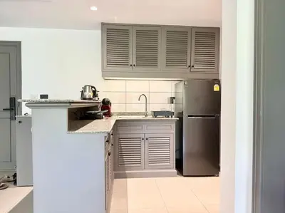 a kitchen with a sink and a refrigerator at Allamanda Laguna Phuket 2 bedroom apartment Bang Tao Beach in Laguna Phuket