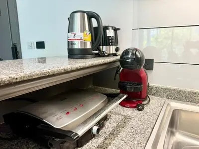 a kitchen counter with a coffee maker and a mixer at Allamanda Laguna Phuket 2 bedroom apartment Bang Tao Beach in Laguna Phuket
