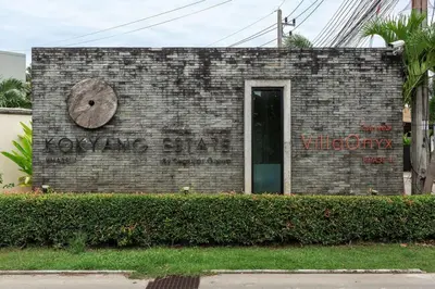 a brick building with a clock on the side of it at Villa Laut 3BR Private Pool 10 min to Nai Harn in Rawai Beach