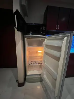 an empty refrigerator with its door open in a kitchen at Patong Tower Apartment - AMP in Patong Beach