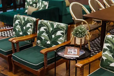 a group of chairs with green and white fabric at Buasri Boutique Patong in Patong Beach