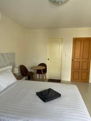 a bedroom with a bed with a black towel on it at Apartments Kata Beach view garden in Kata Beach
