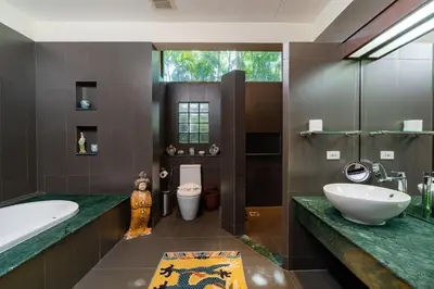 a bathroom with a tub and a sink and a toilet at Baan Mandala Villa 4 in Bang Tao Beach