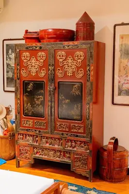an ornate wooden cabinet in a room at Baan Mandala Villa 4 in Bang Tao Beach
