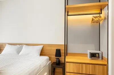 a bedroom with a bed and a clock on a shelf at Laguna Lakeside BangTao by My Home Phuket in Bang Tao Beach
