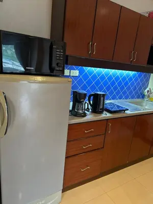 a kitchen with a refrigerator and a microwave at Apartment in Patong Tower in Patong Beach
