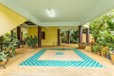 a swimming pool in the middle of a house with plants at V235 Huge Pool 4 Mins Kamala Beach 12 Mins Patong in Kamala Beach