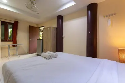 a bedroom with a white bed with towels on it at V235 Huge Pool 4 Mins Kamala Beach 12 Mins Patong in Kamala Beach