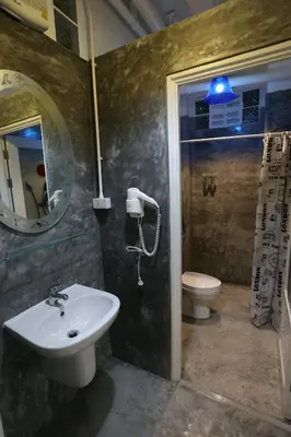 a bathroom with a sink and a toilet with a blue light at iDeal Beds Hostel Ao Nang Beach in Ao Nang Beach