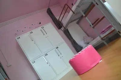 a room with a pink chair and a dressing room at iDeal Beds Hostel Ao Nang Beach in Ao Nang Beach
