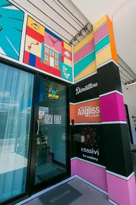 a store front with a colorful wall at Wow Academy & Stay Soi Tai-Aed 2B in Ban Suan